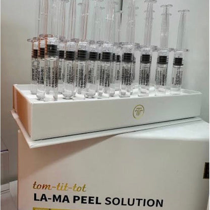 Display of syringes with a box labeled 'LA-MA Peel Solution' on a white background