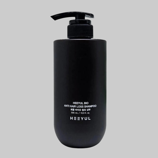 Black shampoo bottle with pump labeled 'HEEYUL BIO ANTI HAIR LOSS SHAMPOO 500ml' on a grey background