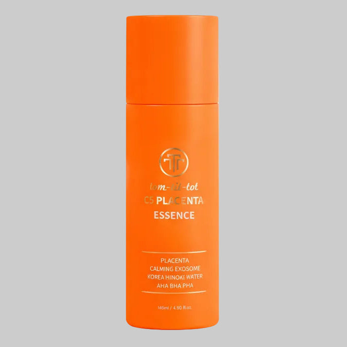 Orange bottle of placenta essence on a gray background