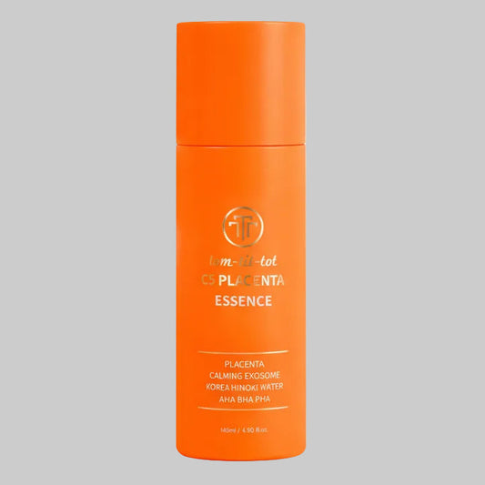 Orange bottle of placenta essence on a gray background