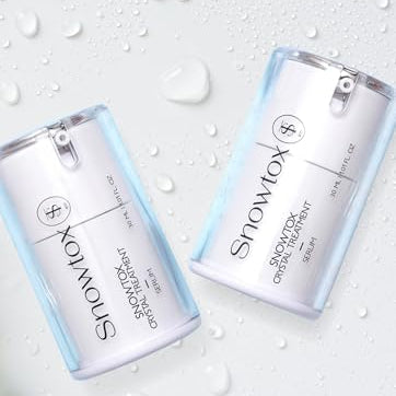 Two bottles of Showtox crystal treatment serumm on a light gray background with water droplets.